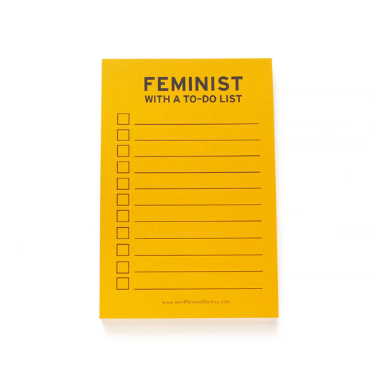 Yellow notepad with the header "feminist with a to-do list" and a blank checklist.